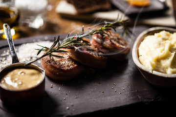 Pork tenderloin served on a board in restaurant