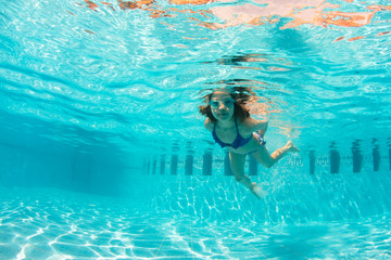 Underwater Young Girl Fun in the Swimming Pool with Goggles. summer concept. Summer Vacation Fun