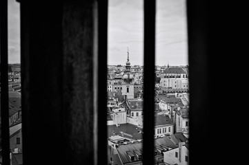 Panoramic view of Prague through the window of an ancient building (Prague, Czech Republic, Europe)