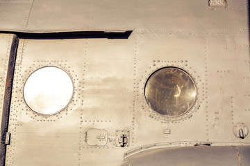 Porthole transport helicopter. Background with rivets.
