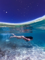 Obraz na płótnie Canvas swimming underwater at night