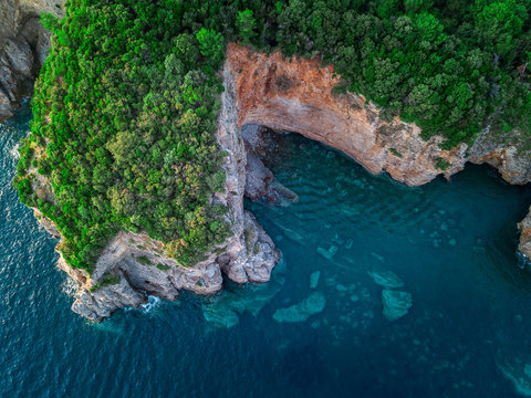 Aerial view of a steep cliff, unspoiled nature of the Montenegro coast. Sea caves and inlets alternate on the Mediterranean coast © Naeblys