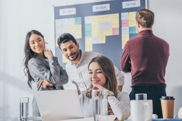 selective focus of multicultural businesswomen and businessman working in office