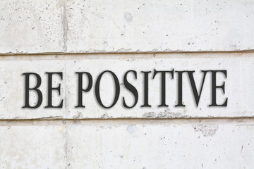 written BE POSITIVE words on concrete wall background