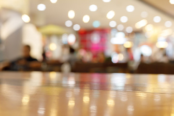 wooden table empty of display in cafe with luxury light decoration