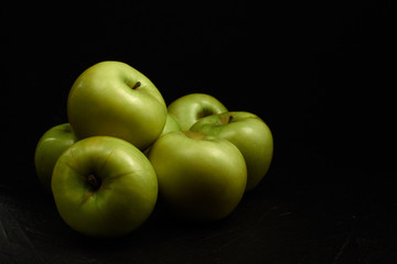 Green apples Simirenko at black background with copy space