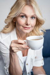 Placid pleasant lady having a tea break