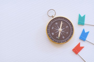 Compass, vintage hanging necklace watch and flag pin on white background, direction concept - 314702263