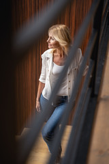 Smiling stylish lady standing on the staircase