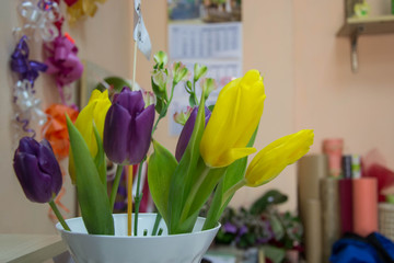 Close-up of beautiful tulip flowers on a flower shop, selective focus, green leaves