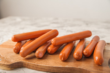 Close-up of sausages. Sausages on the blackboard and place for text. Boiled raw bavarian sausages and copy space.