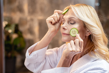 Mature woman relaxing with a facial mask