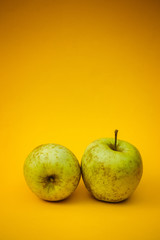 Bio green apples on a yellow background