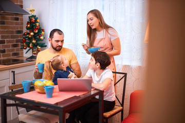 friendly caucasian family together in kitchen at home, spend leisure time while having breakfast or launch, happy children and parents indoors