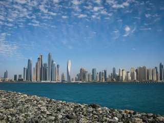 view of the beach and skyscrapers from the promenade of the artificial island Palm Jumeirah, Dubai,...