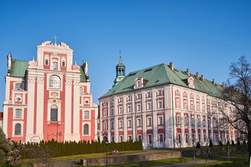 Obraz premium The facade of the Baroque Catholic Church and a historic religious building in Poznan.