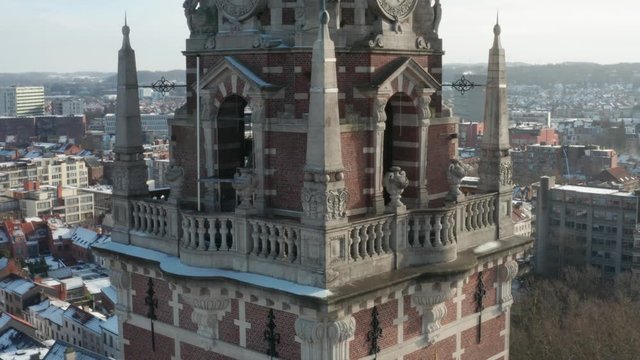 Aerial shot of historic city tower in Leuven in Winter snow