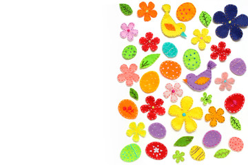 Easter border design on white. Festive background of colored eggs, flowers, birds, leaves, decorated with embroidery. 