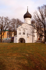 Fototapeta na wymiar White-stone Orthodox church with black domes in the city of Pskov (Russia)