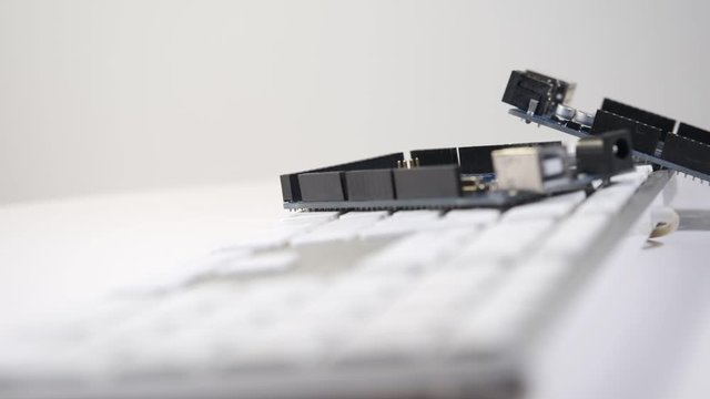 Two DIY boards lie on the keyboard and slide into the frame smoothly. 360 degree rotation. The atmosphere of fablab.