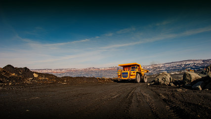 truck in an iron ore quarry transports raw materials.