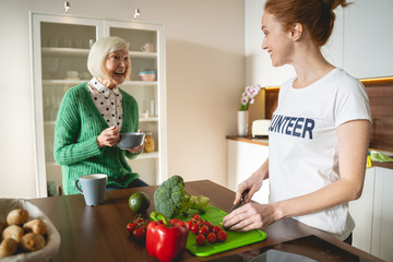 Kind blonde mature woman laughing at joke