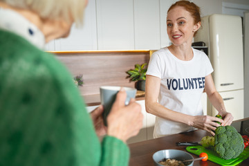 Cute young female person having pleasant conversation