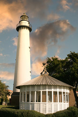 White gazebo and lighthouse against blue sky