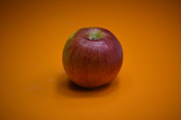 Fresh apple on orange background