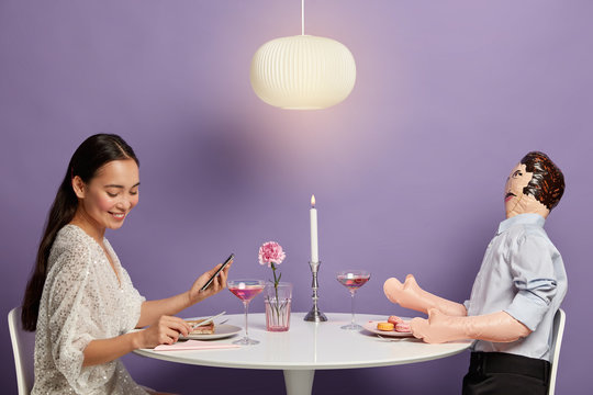 Shy woman lives virtual life, has love online, finds couple via dating application, has delicious supper together with inflated male doll, uses layman not to feel lonely and bored, isolated on purple