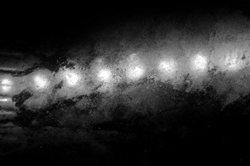 White light bulbs on a black background. A grim, icy abstraction. The glow of illumination in the...