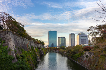 Cloudscape and skyline urban cityscape reflection at Osaka Castle Park, Japan.