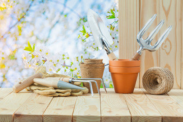 gardening tools on wooden table in garden