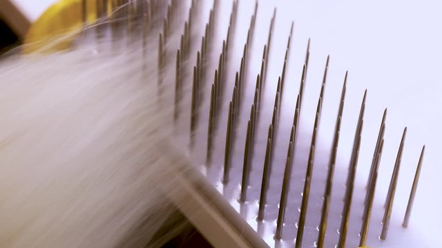 Hair combing when creating a wig. Factory wig production process