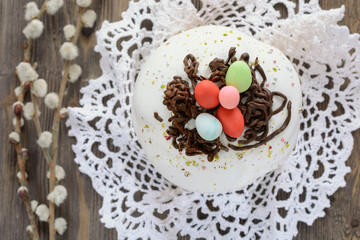 Easter cake decorated sweet colored eggs next willow twig, top view
