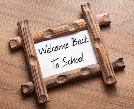 Text Welcome Back To School written on wood frame
