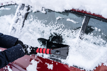 Woman Cleaning Car From Snow