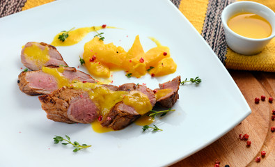 Meat, steak, poultry, duck, roast beef, side dish, thyme on a white plate