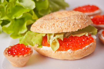 Fresh red caviar on bread. Sandwiches with red caviar and tartles with red caviar. Delicatessen. Gourmet food