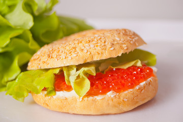 Fresh red caviar on bread bagel. Sandwiche with red caviar. Delicatessen. Gourmet food