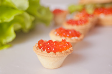 Fresh red caviar in tartlets. Delicatessen. Gourmet food