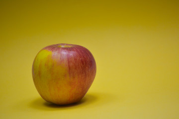 Fresh apple on yellow background