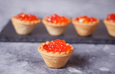 Fresh red caviar in tartlets. Delicatessen. Gourmet food