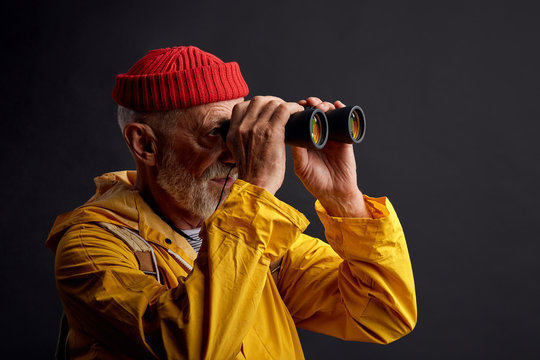 old hunter watching animals, burds for hunting, killing them. close up side view photo. lifestyle, hobby, interets, isolated black background, studio shot