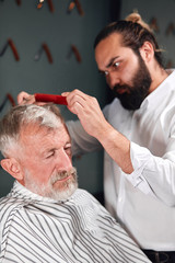 professional talented barber making haircut, close up photo
