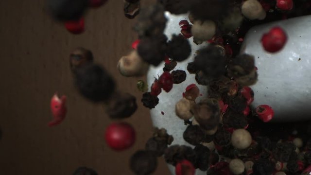 Mixed Pepper Seeds Crushed with Marble Mortar and Pestle on a Wooden background Shot in High-Speed at 1500 fps