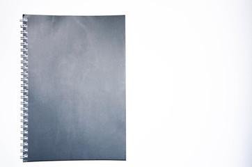 Gray notebook with white pen on a white background. Notepad for notes, ideas, tasks. A diary