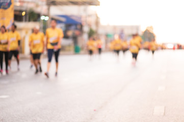 Out of focus and blurry background of marathon running race at the city road in the morning time.Family outdoor exercise for healthy.