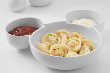close up view of plate with dumplings  on white background.