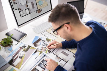 Real Estate Designer Working On Computer